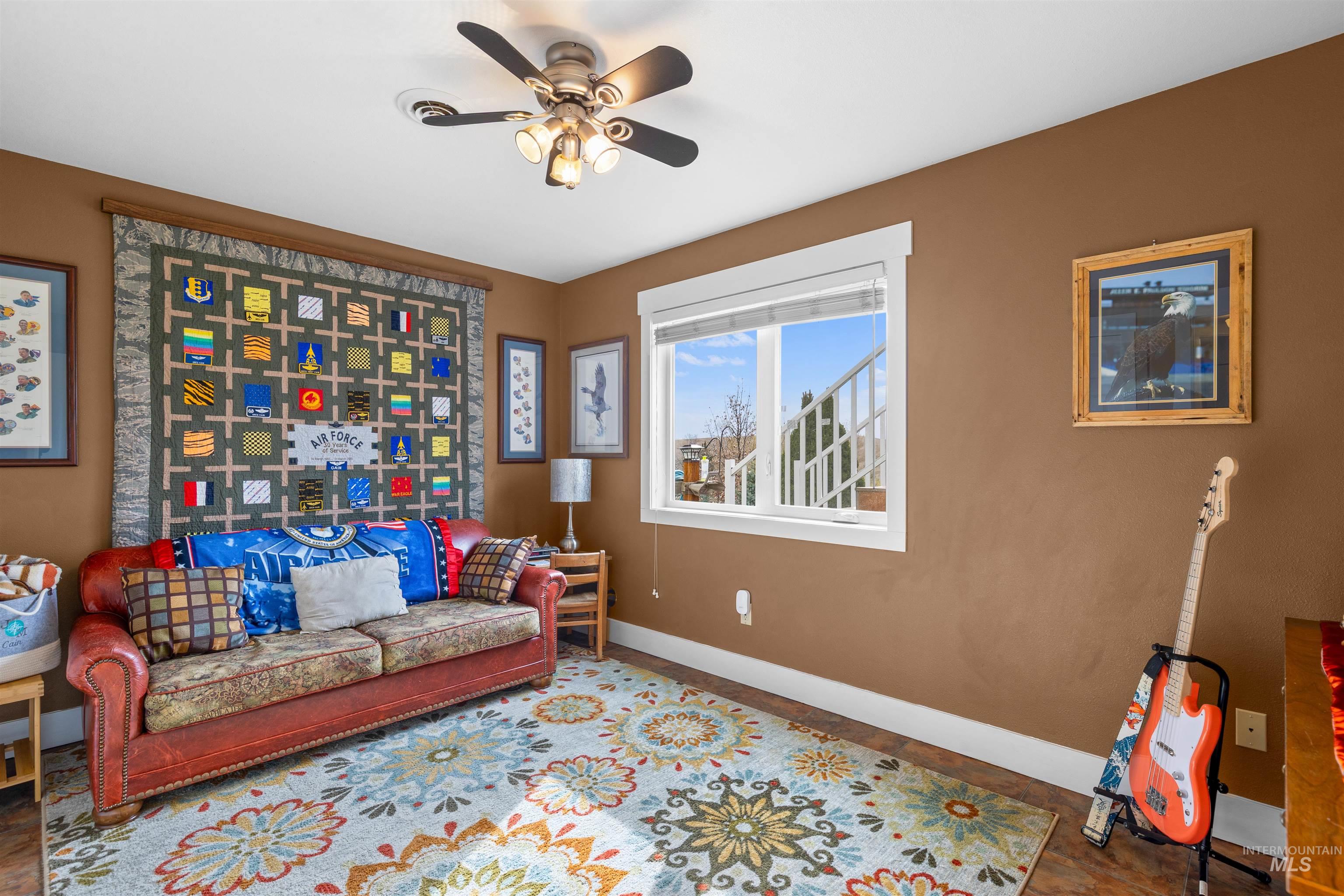 2435 Arborcrest Road Moscow, ID 83843 - Photo 32 of 48 Living area featuring a ceiling fan and baseboards