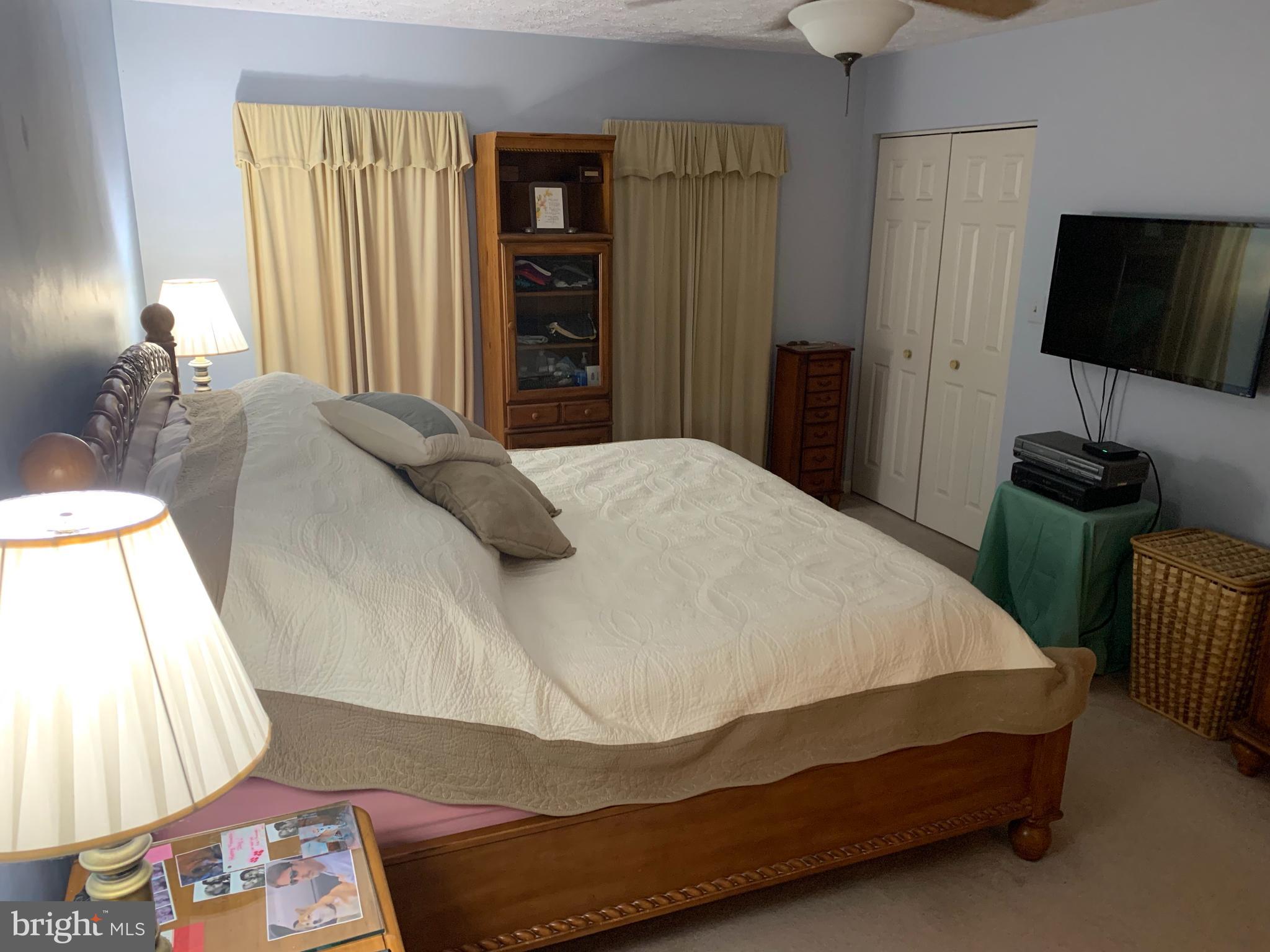 3123 Laurel View Drive Abingdon, MD 21009 - Photo 115 of 135 a bedroom with a bed and a flat tv screen on dresser