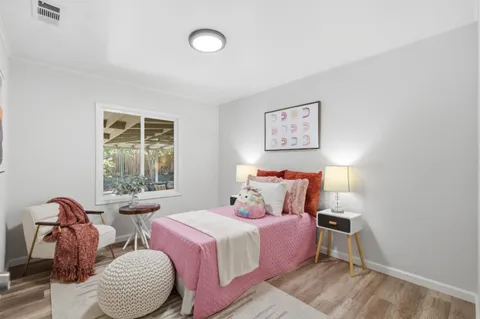 a bedroom with a bed and a painting on the wall