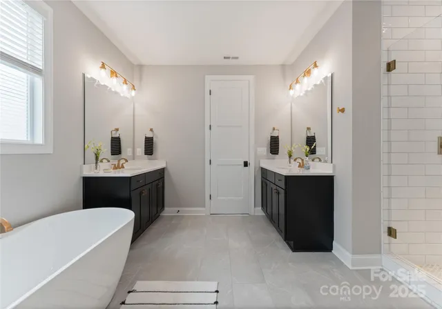 a bathroom with a tub sink and mirror