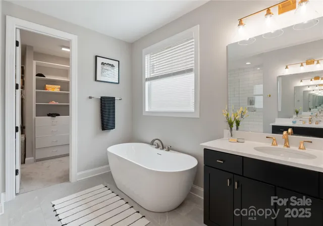 a bathroom with a bathtub sink shower and mirror