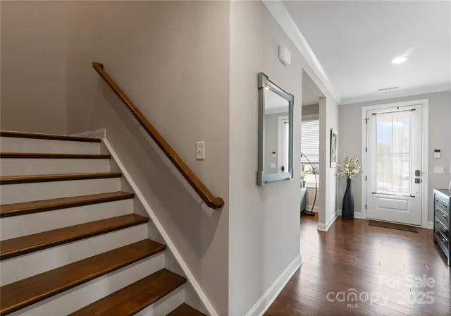 a view of an entryway with wooden floor and windows