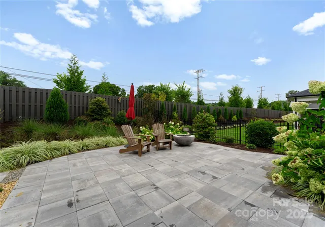 a view of a backyard with sitting area and garden