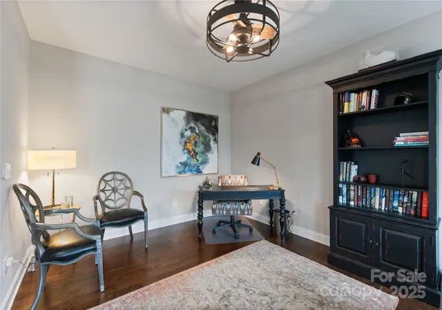 a workspace with furniture bookshelf and a window