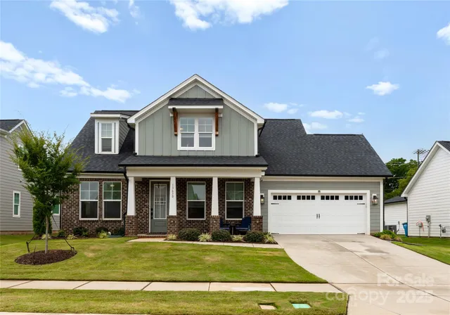a view of a house with a yard patio and fire pit