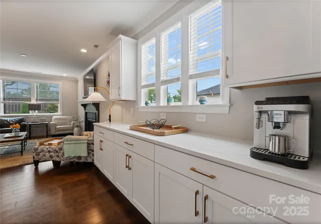 a kitchen that has a lot of cabinets and wooden floor