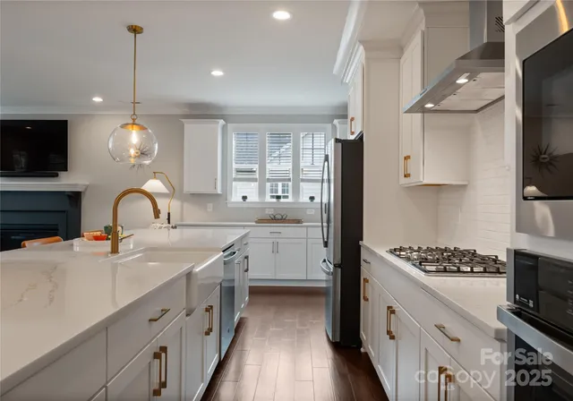 a kitchen with white cabinets and appliances