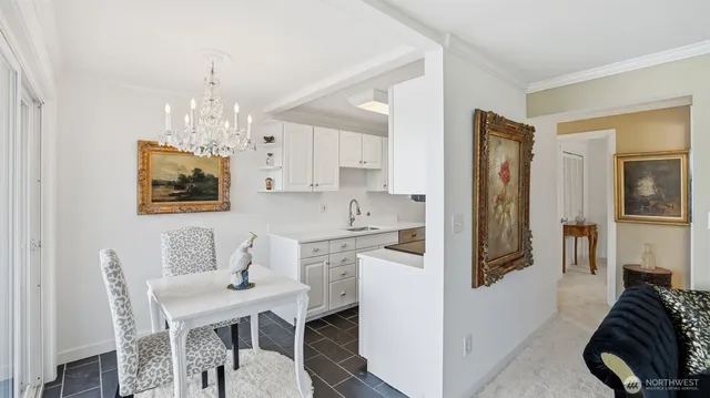 a view of a dining room with furniture and chandelier