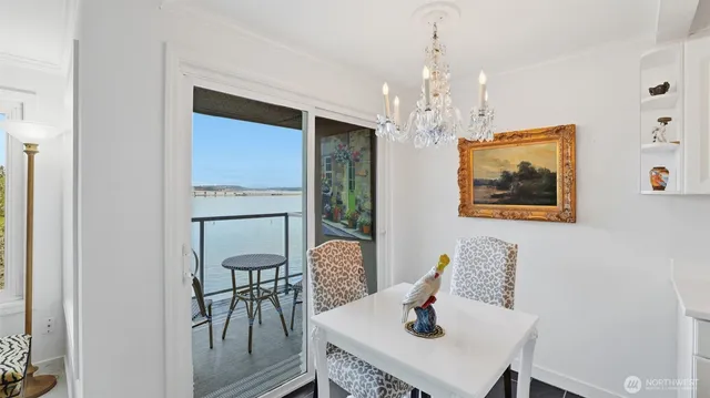 a living room with furniture a flat screen tv and a refrigerator