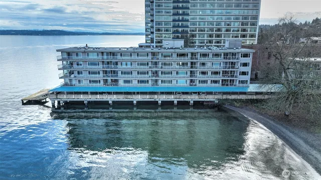 a view of roof deck with wooden floor and lake view
