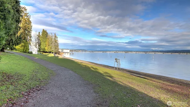 a view of a terrace with wooden floor and lake view