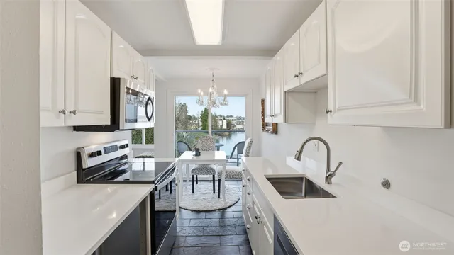 a kitchen with stainless steel appliances a sink stove and refrigerator