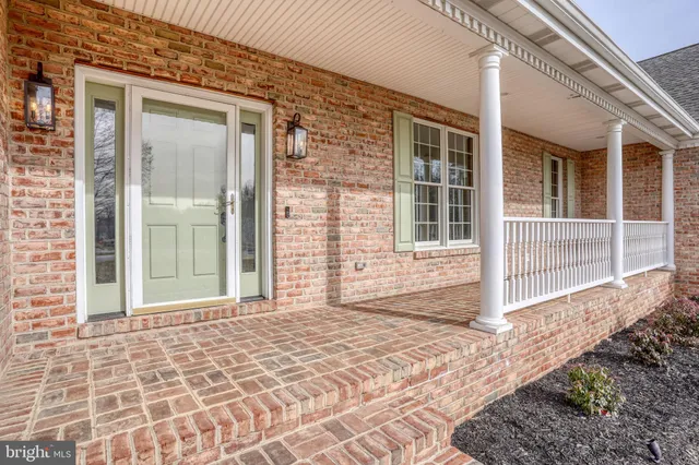 a view of a room with wooden floor chandelier and a window