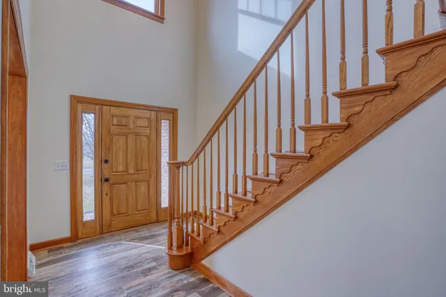 a kitchen that has a lot of cabinets in it and wooden floors