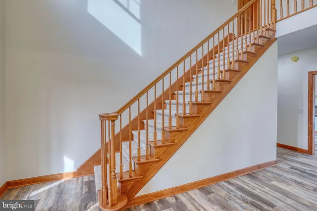 a kitchen with stainless steel appliances granite countertop a refrigerator a stove and a sink