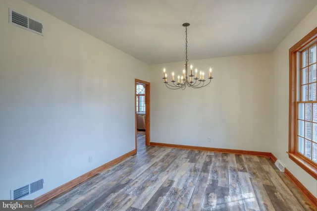 a kitchen with stainless steel appliances granite countertop a stove a sink and a granite counter tops with wooden floors