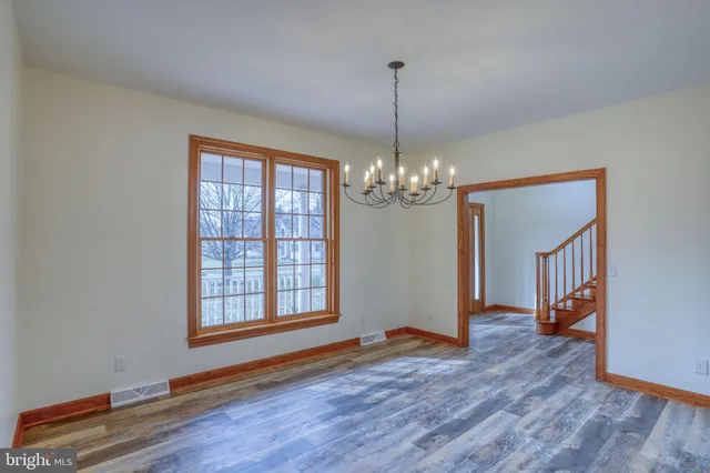 a kitchen with stainless steel appliances granite countertop wooden floors and view living room