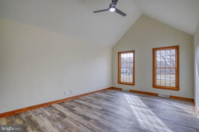 an aerial view of residential houses with outdoor space and trees