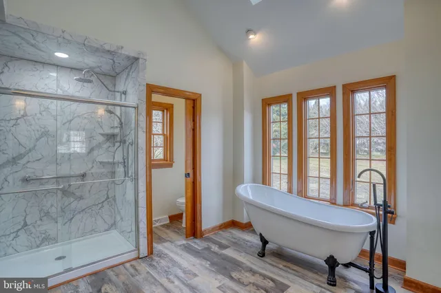 an aerial view of a house with a garden and lake view