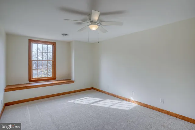 an aerial view of a house with garden space and mountain view in back