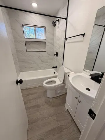 a bathroom with a sink a toilet and a bathtub