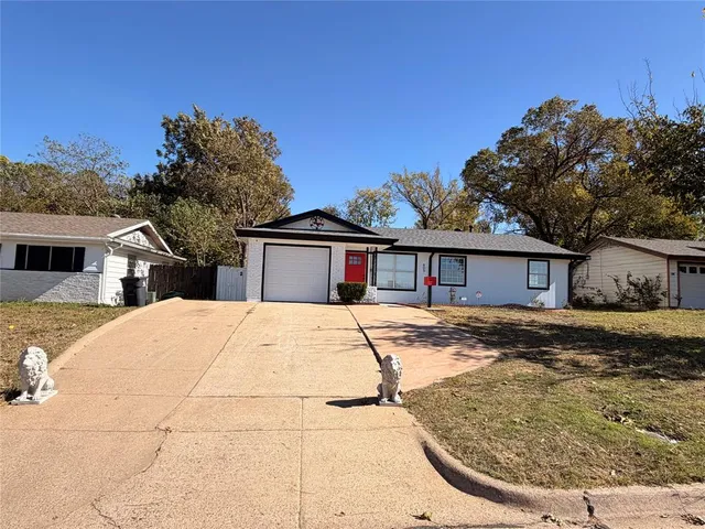 a view of a house with snow on the side of the road
