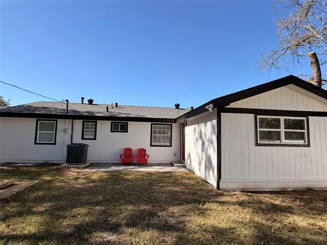 a view of a house with wooden fence