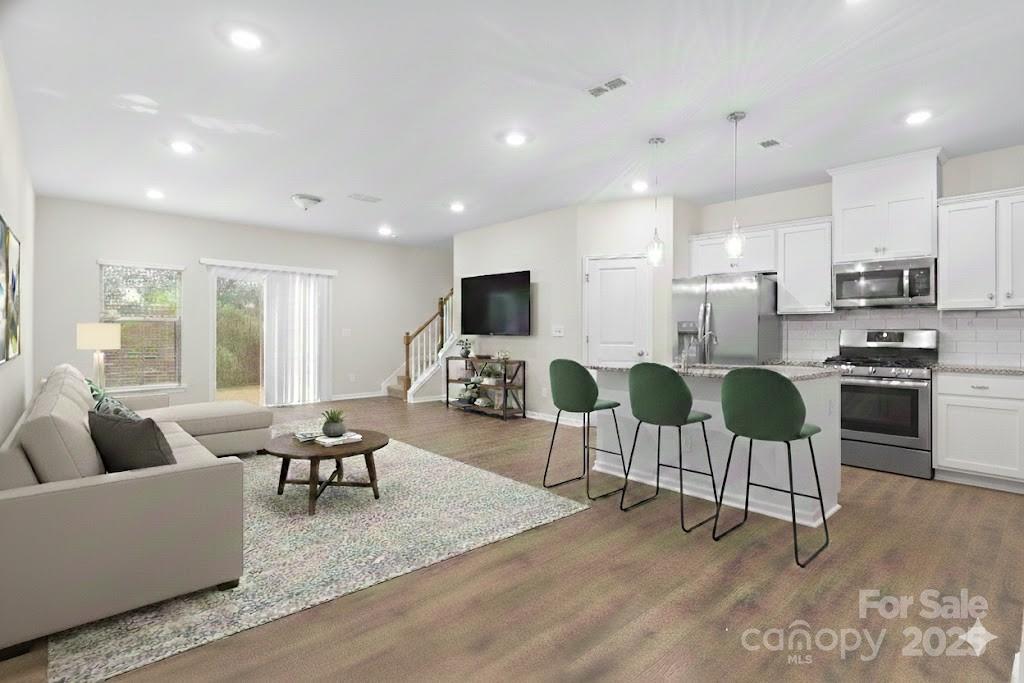 5215 Maynard Hl Drive Monroe, NC 28110 - Photo 7 of 34 a living room with furniture and a flat screen tv