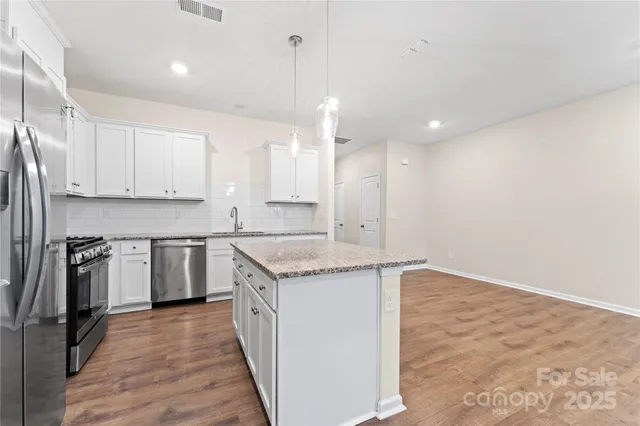 a view of kitchen and refrigerator
