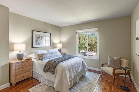 a bed room with a bed and a chair