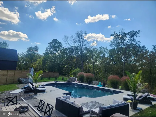 a view of a backyard with sitting area