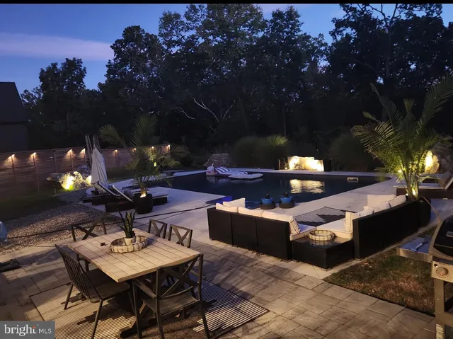 a view of a patio with table and chairs and a fire pit
