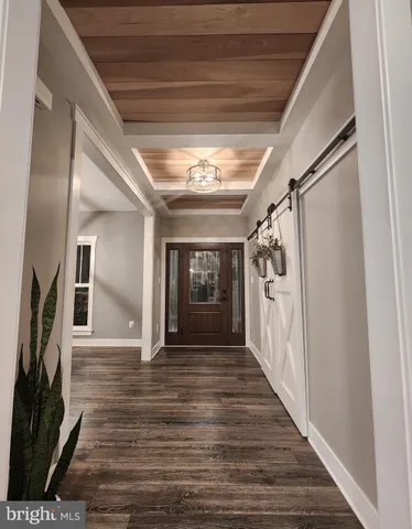 a view of a hallway with wooden floor and a fireplace