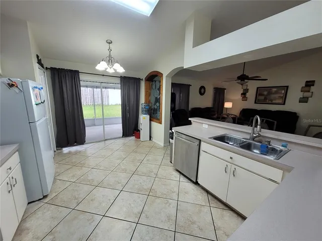 a bed room with a bed and a ceiling fan