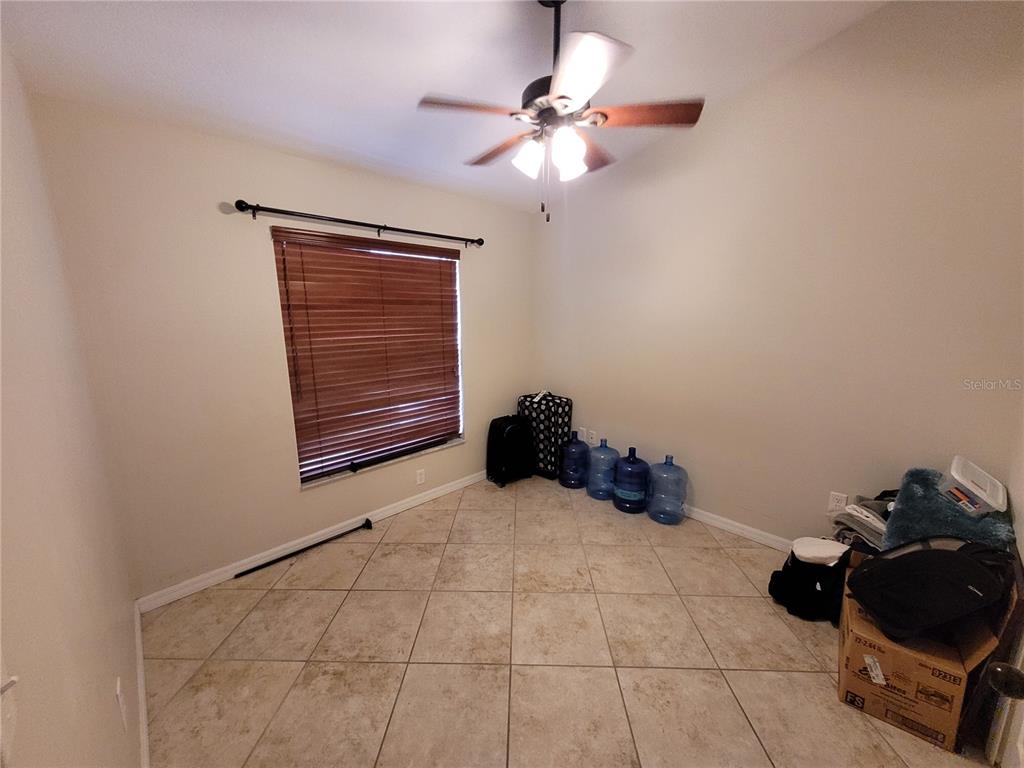 4233 Amber Ridge Lane Valrico, FL 33594 - Photo 14 of 40 a bed room with a bed and a ceiling fan