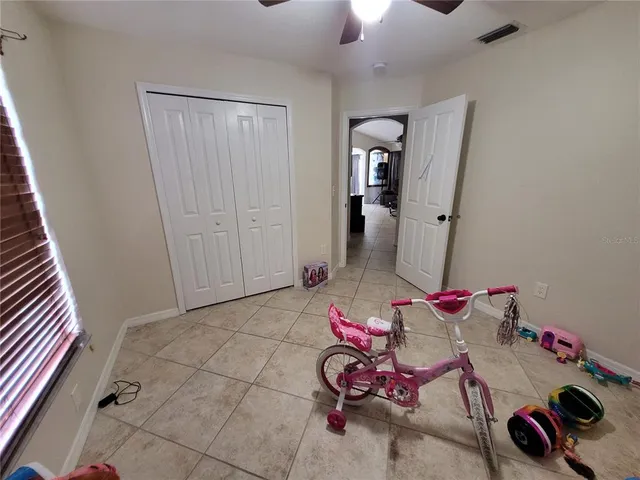 a bed sitting in a room next to a window