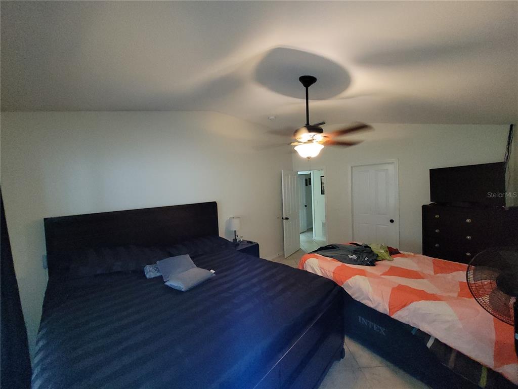 4233 Amber Ridge Lane Valrico, FL 33594 - Photo 22 of 40 a bedroom with a bed and a chandelier