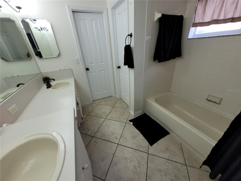 4233 Amber Ridge Lane Valrico, FL 33594 - Photo 25 of 40 a bathroom with a bathtub and shower