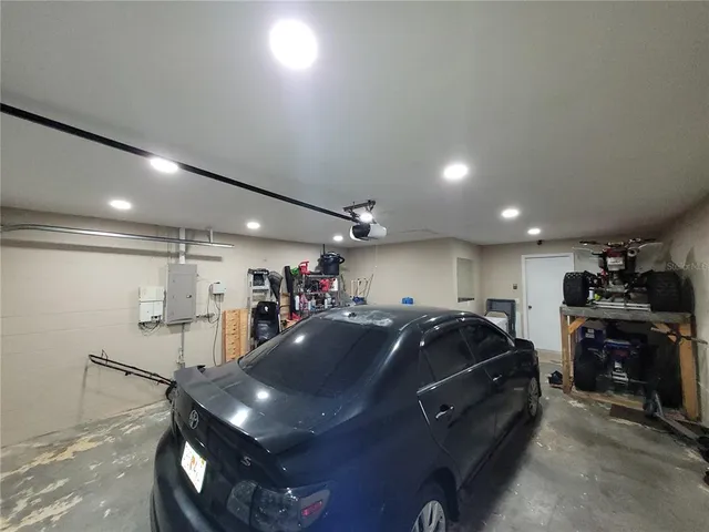 a backyard of a house with wooden fence table and chairs