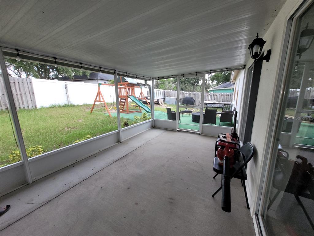 4233 Amber Ridge Lane Valrico, FL 33594 - Photo 34 of 40 a view of backyard with deck and outdoor seating