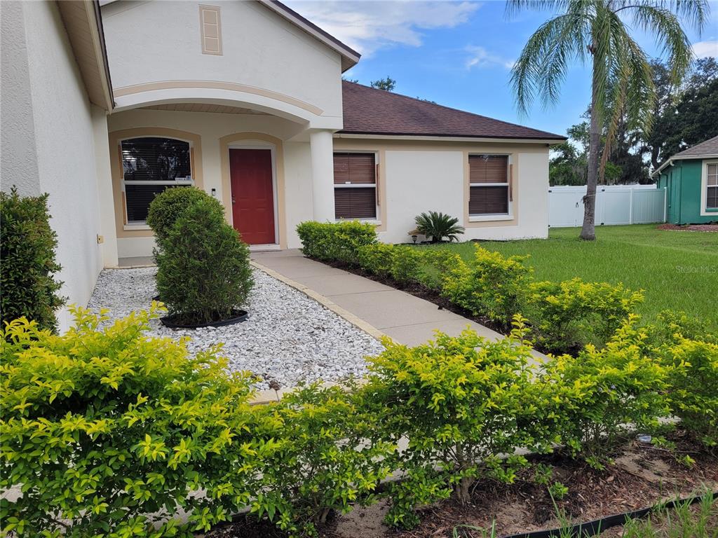 4233 Amber Ridge Lane Valrico, FL 33594 - Photo 5 of 40 a front view of a house with garden
