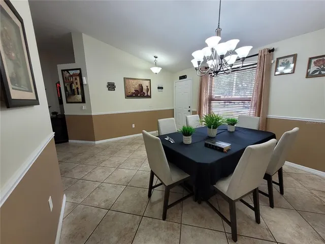 a view of a dining room with furniture and chandelier