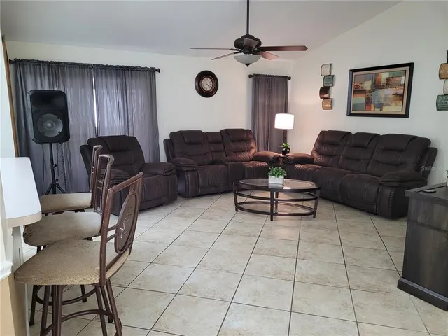 a living room with patio furniture and a window