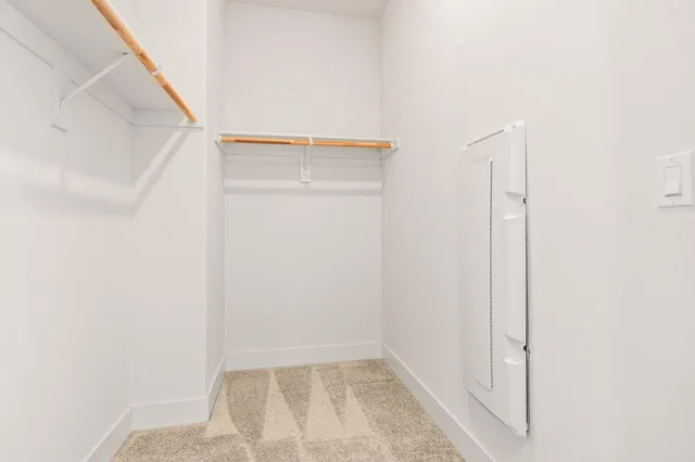 a spacious bathroom with a granite countertop sink a toilet and a mirror