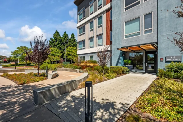a view of a house with a yard and sitting area