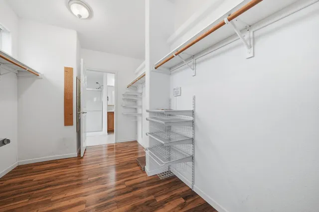 a view of walk in closet with empty racks