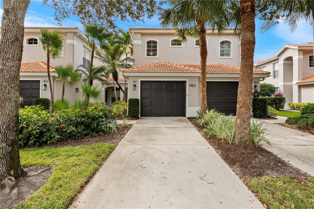 1953 Crestview Way, Unit 161 Naples, FL 34119 - Photo 1 of 37 a front view of a house with a garden