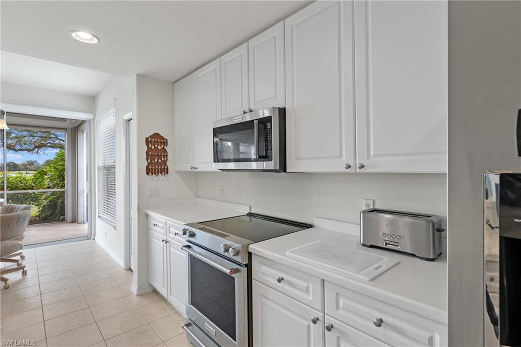 1953 Crestview Way, Unit 161 Naples, FL 34119 - Photo 11 of 37 a kitchen with granite countertop white cabinets and stainless steel appliances