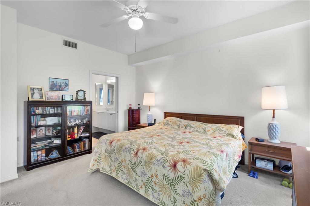 1953 Crestview Way, Unit 161 Naples, FL 34119 - Photo 16 of 37 a bedroom with a bed and a bookshelf