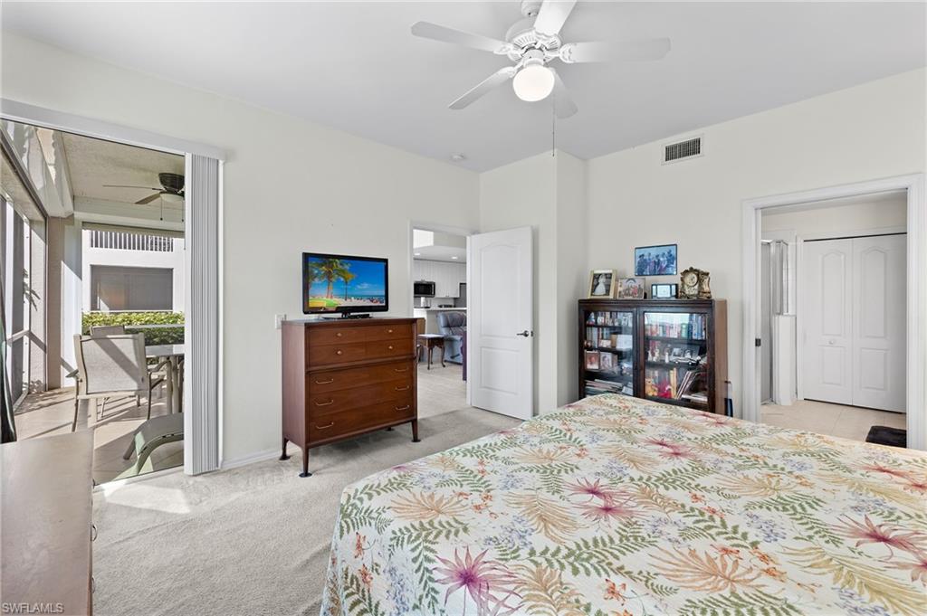 1953 Crestview Way, Unit 161 Naples, FL 34119 - Photo 17 of 37 a bedroom with a bed and a television